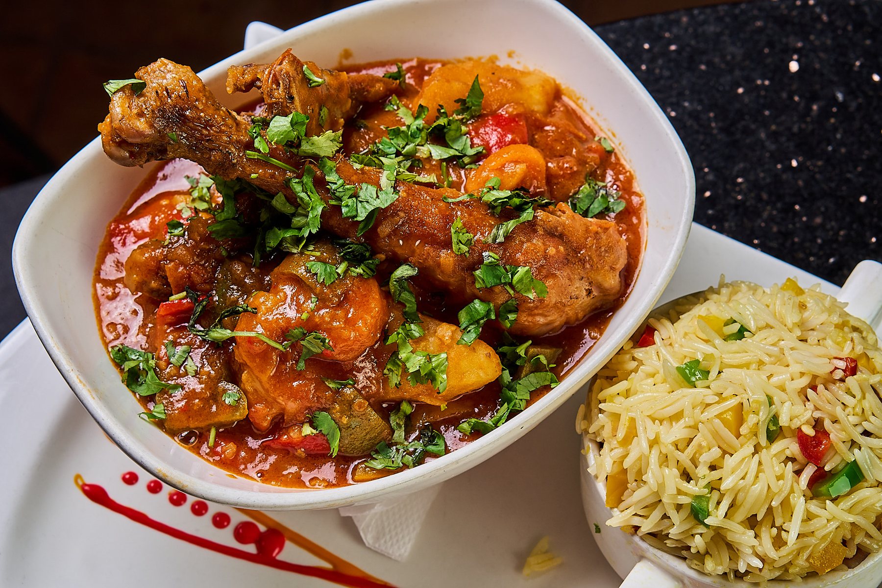 Caribbean jerk chicken plated with herbs